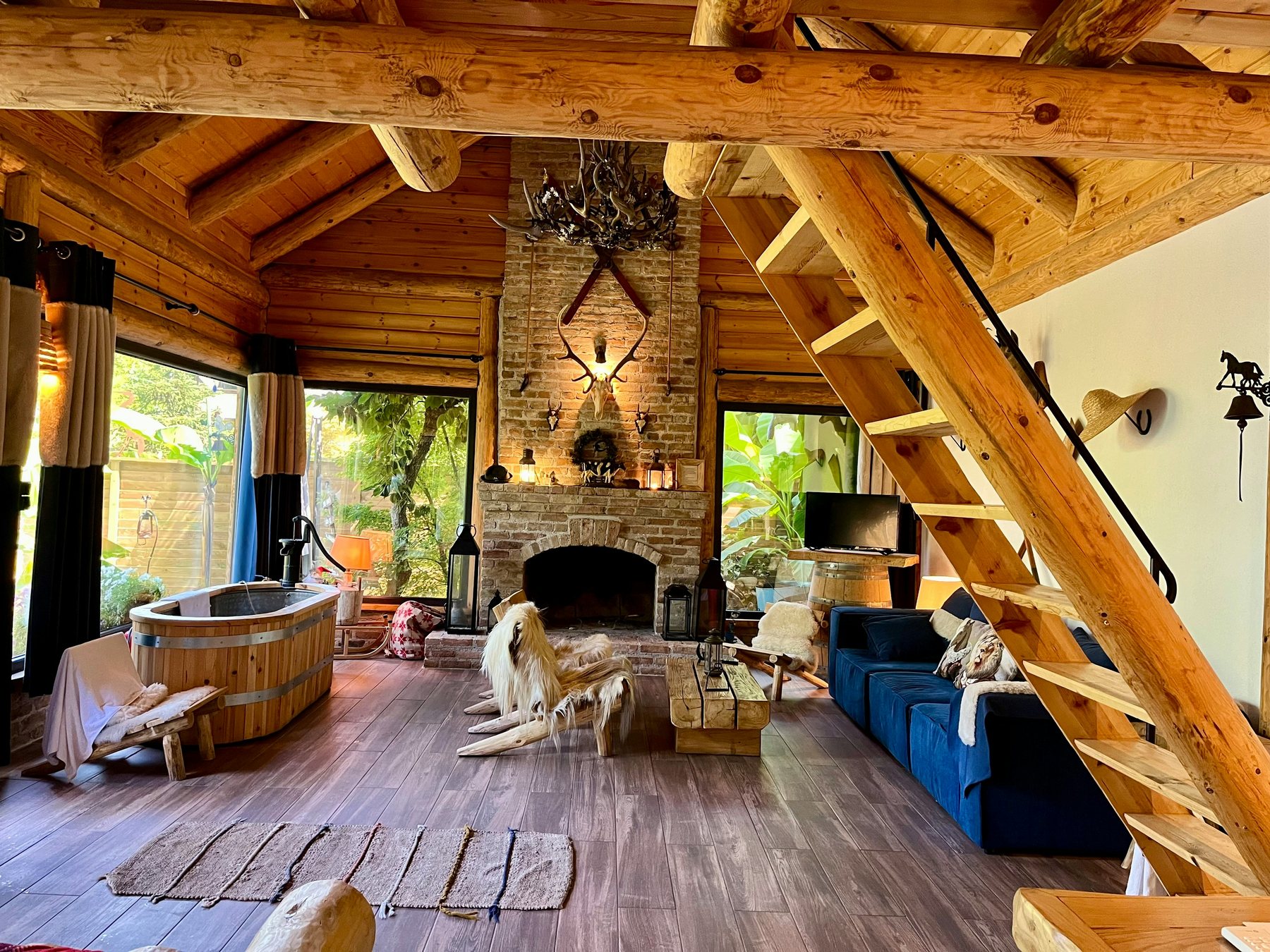 Warm rustic cabin interior with wood finishes and a fireplace