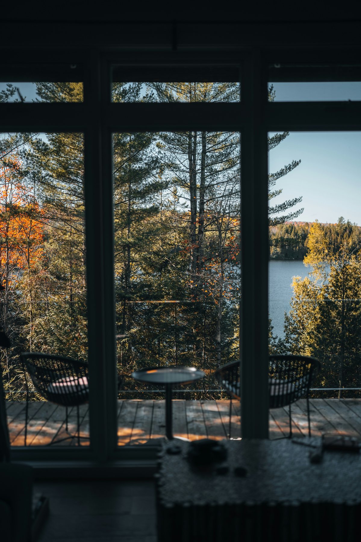 Cabin view across a forest and lake
